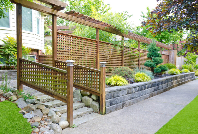 A timber fence skirting the outside of a home